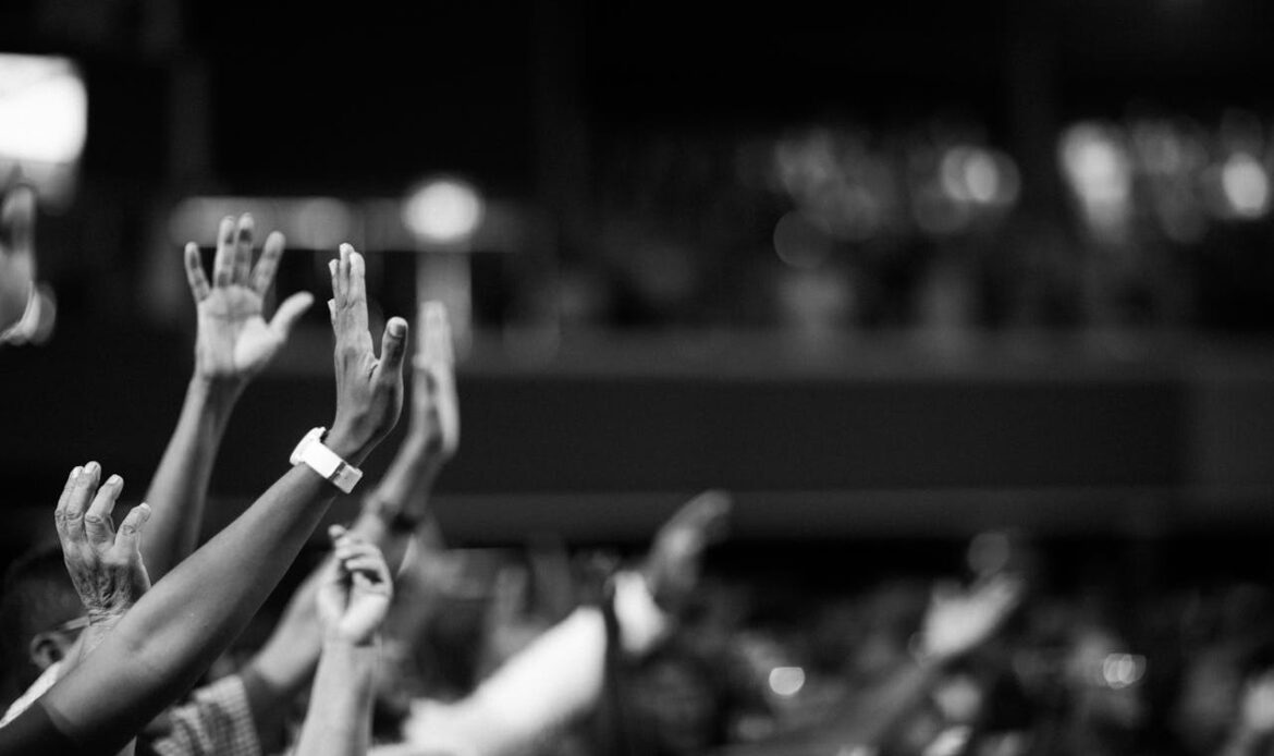 Grayscale Photography Of Hands Waving